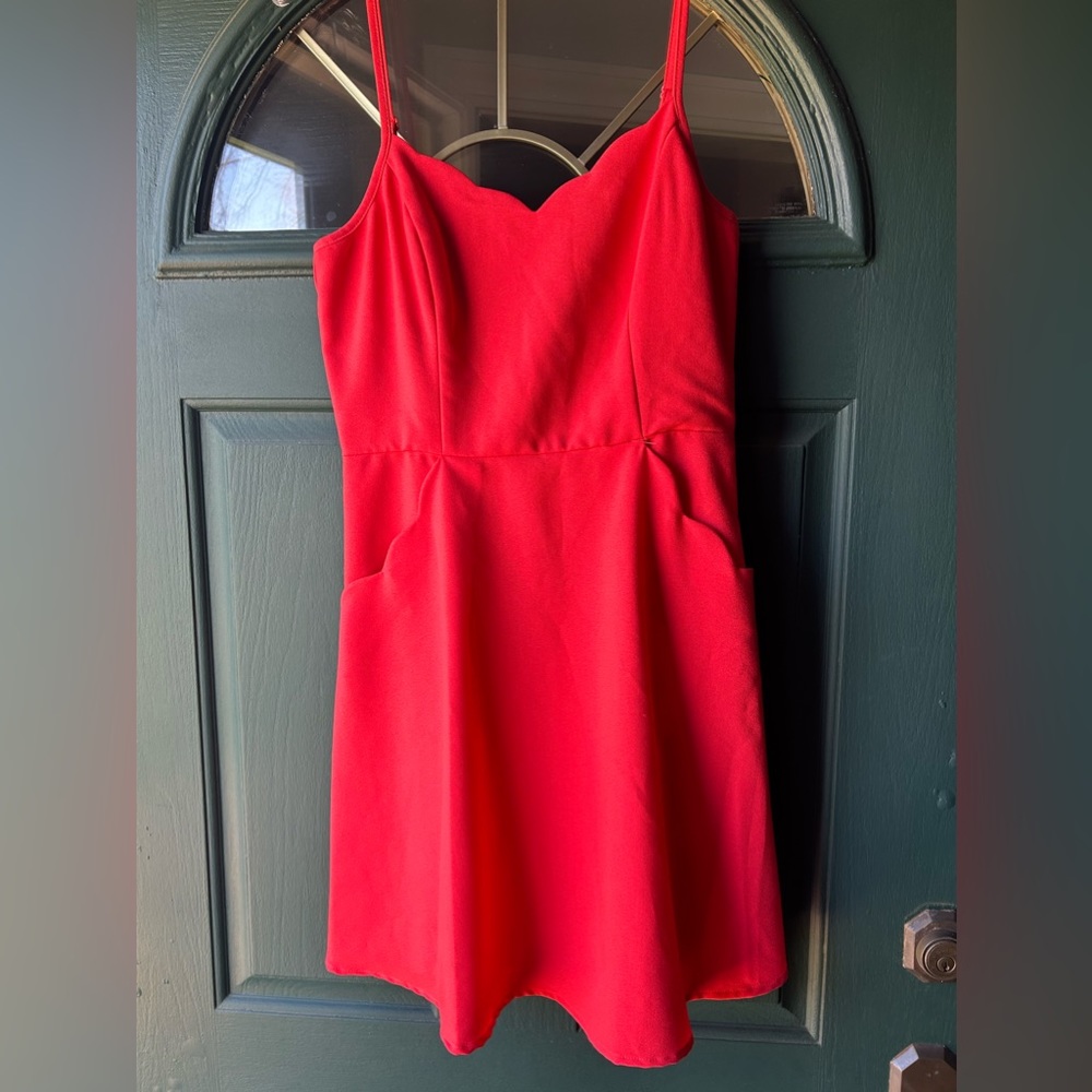 Bright coral dress with scallop pockets and neckline